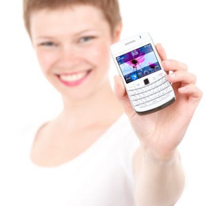 Why is she smiling? Because she's about to drop her Blackberry in the trash, and join the tech age.